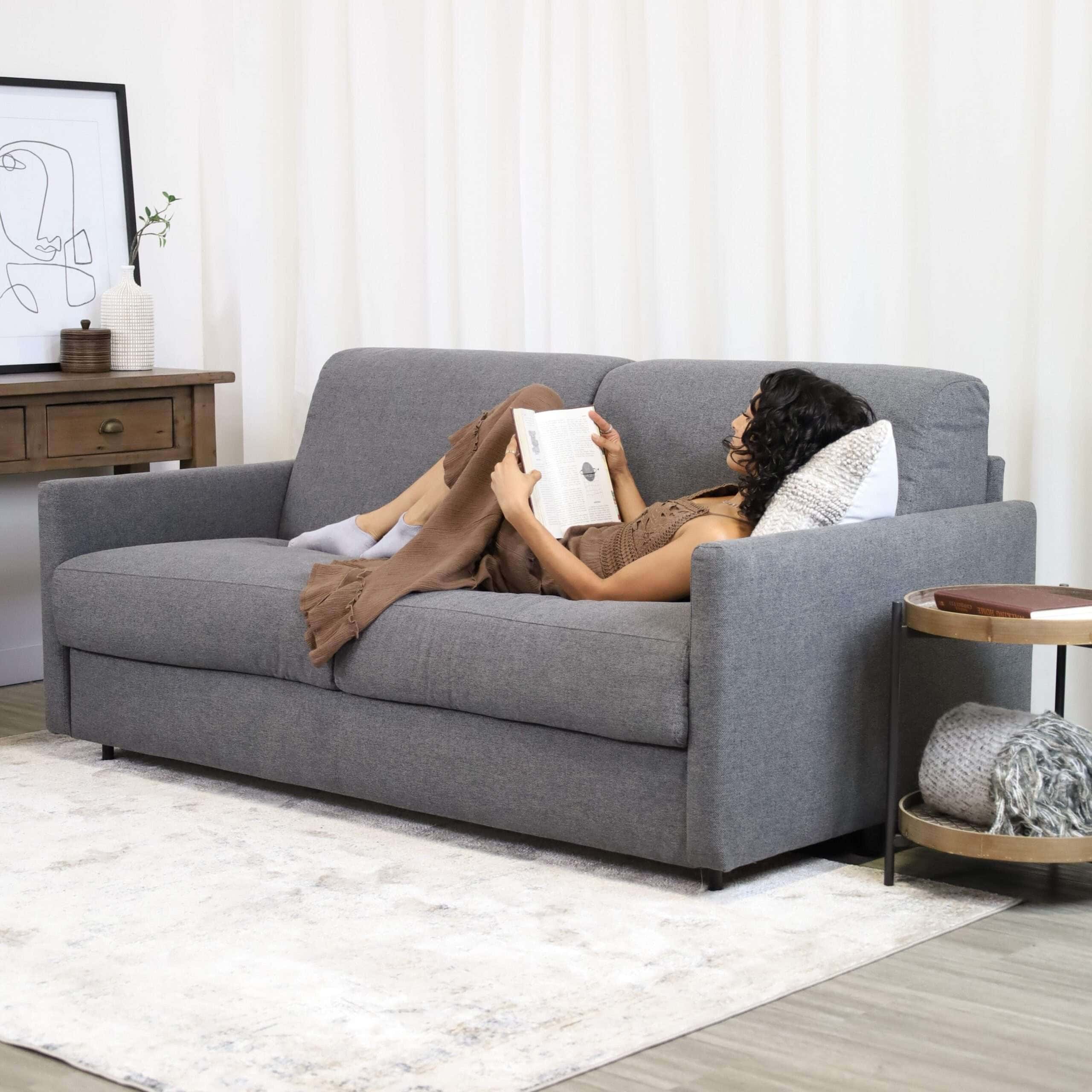 Woman reading on a pull out sofa bed